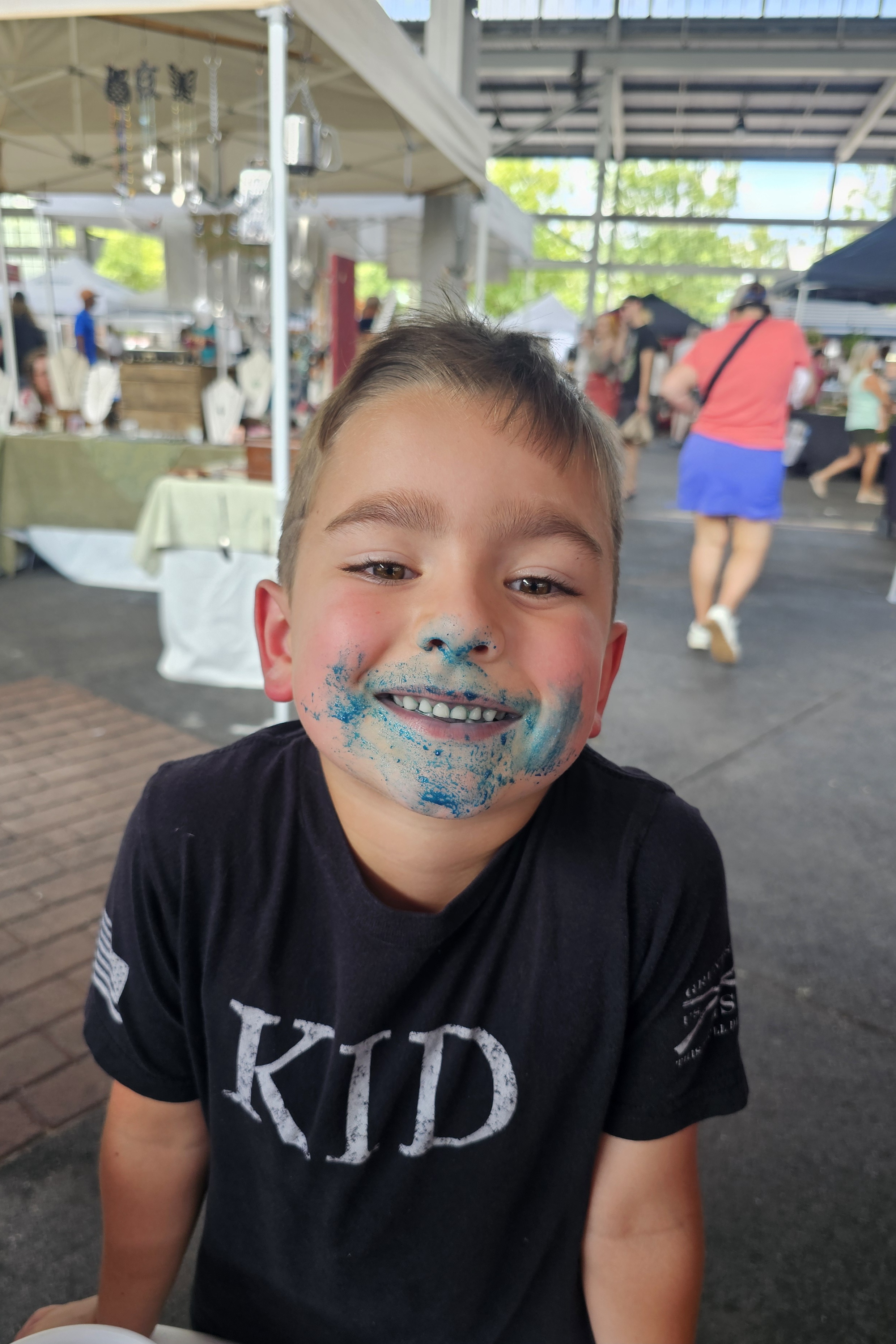 Boy with a blue cotton candy mustache