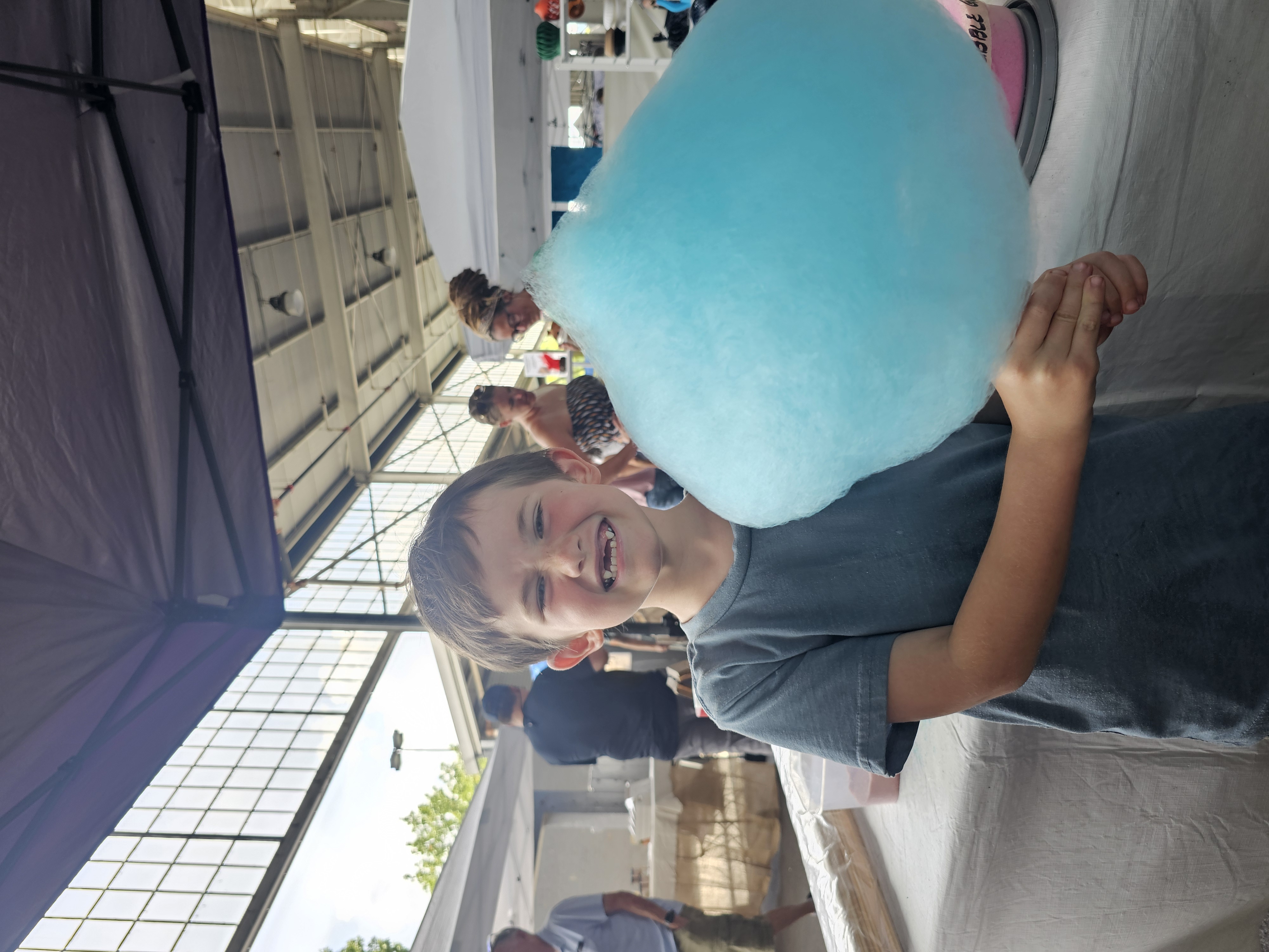 Boy holding a huge blue cotton candy at the Chattanooga Market