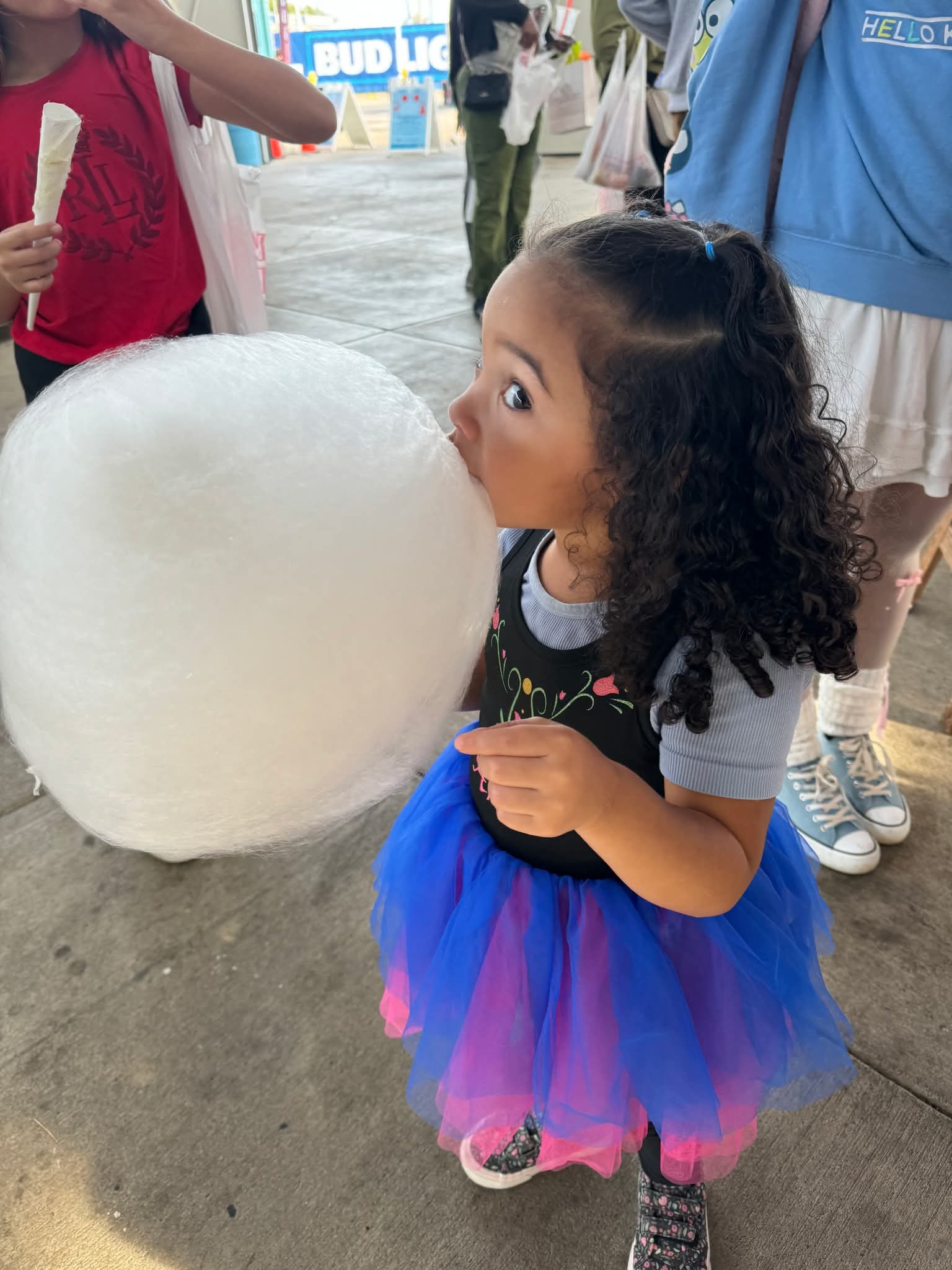 Toddler in a blue tutu with white cotton candy