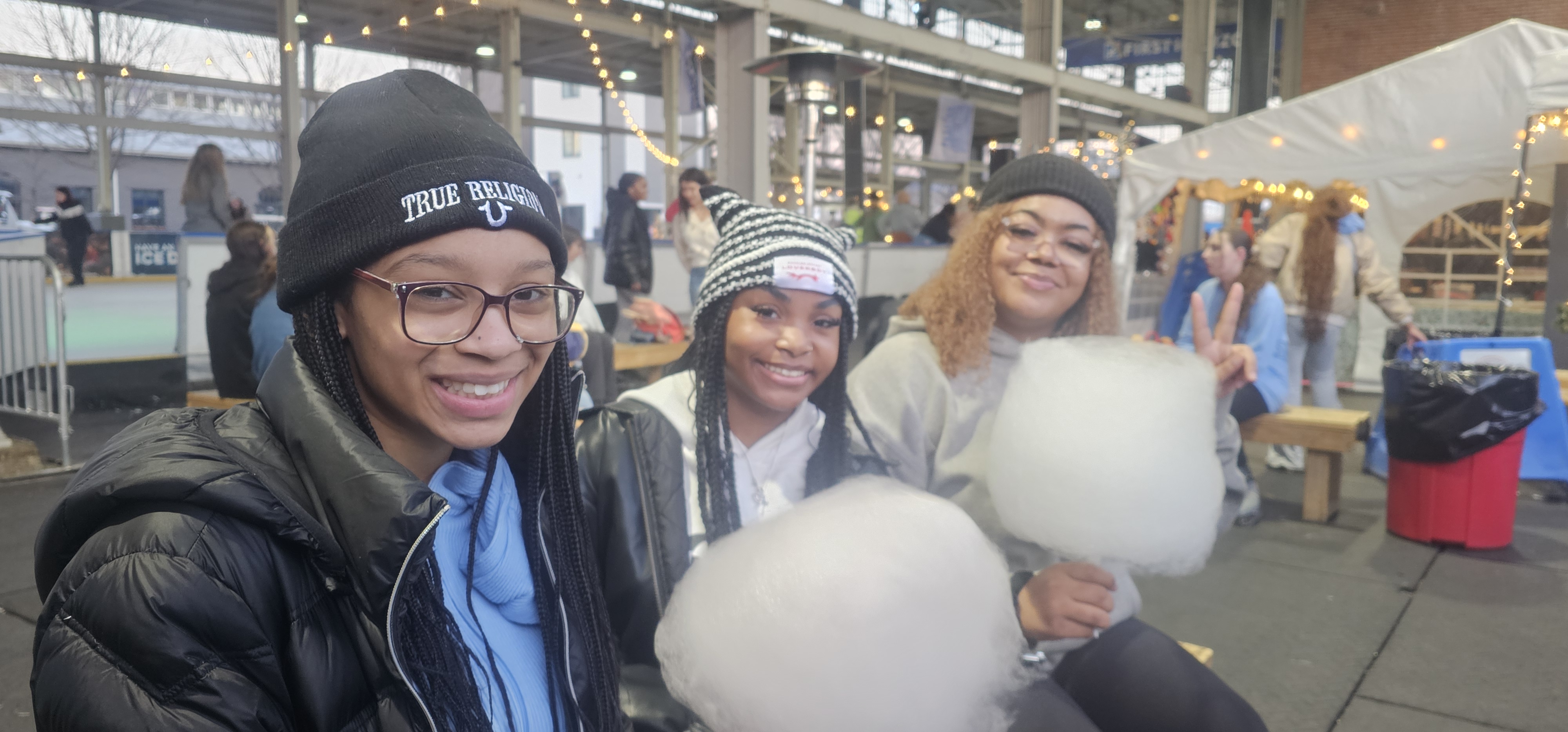 Three friends with cotton candy at Ice on the Landing